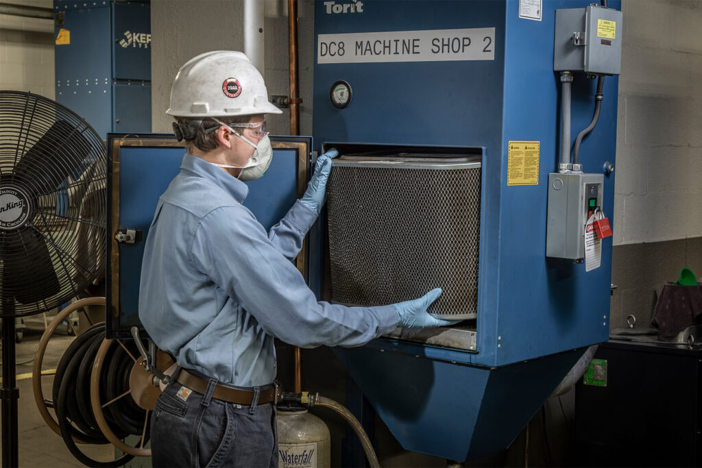 DenTechn technician replacing dust collector filters