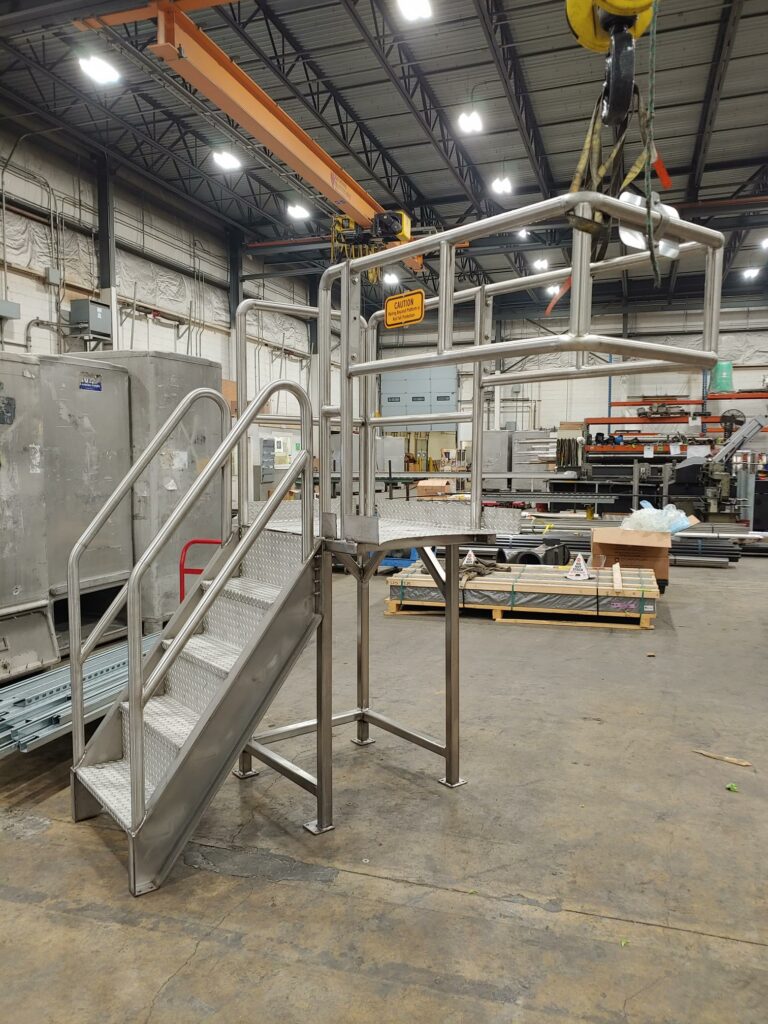 Stainless-steel fabricated platform (side view) in a warehouse